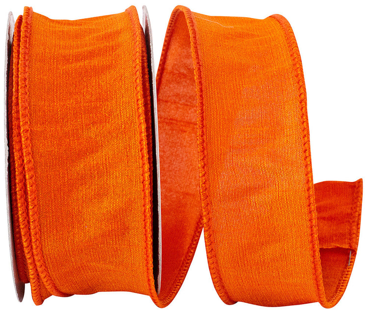 A spool of 1.5-inch wide tangerine orange dupioni ribbon with a wired edge.