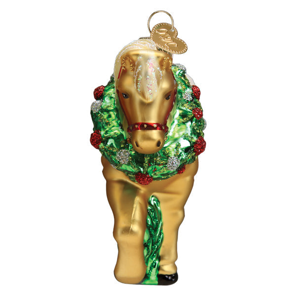 Golden horse glass ornament wearing a green wreath with red and silver glitter accents.
