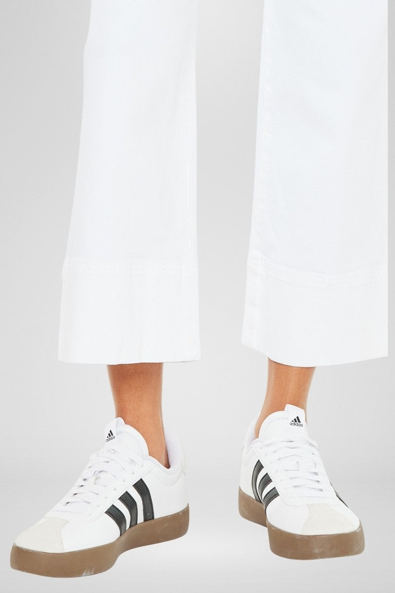 High rise wide leg cropped jeans in faded denim with a slant pocket.