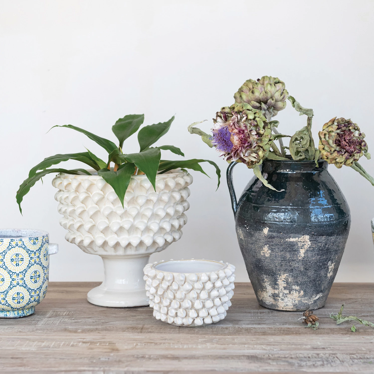 Round stoneware planter with a cube-shaped silhouette in dark gray.