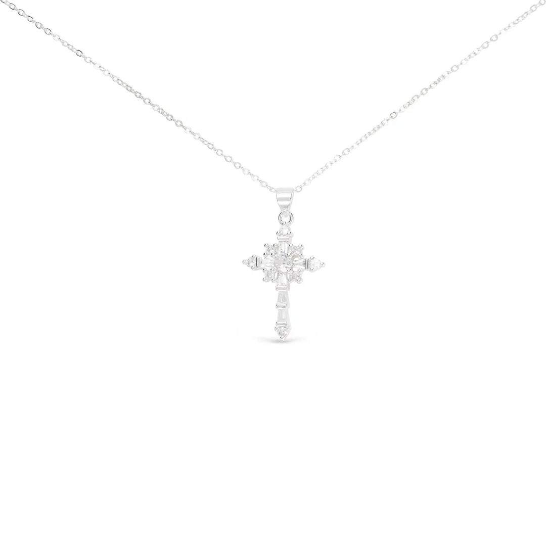 Silver celestial cross necklace with star-like cubic zirconia stones on a delicate chain.