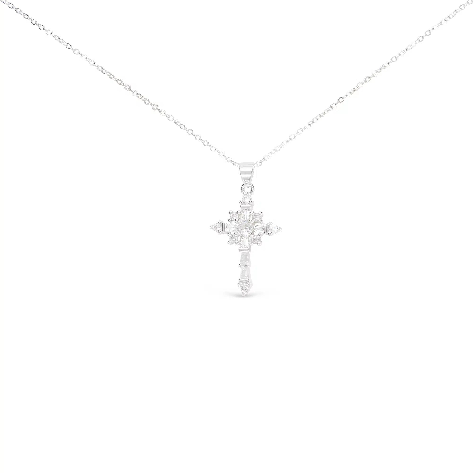 Silver celestial cross necklace with star-like cubic zirconia stones on a delicate chain.