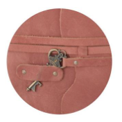 Close-up of a pink leather journal with an antique skeleton key slip-clasp closure.