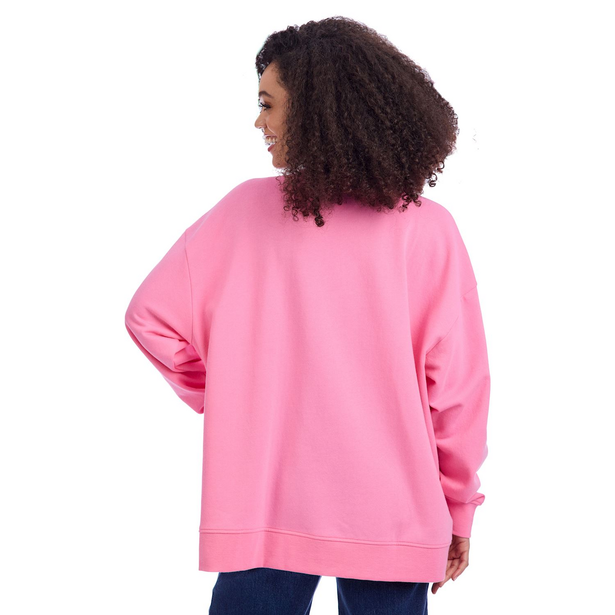Back view of a woman wearing an oversized pink Valentine's Sparkle Sweatshirt and blue jeans.