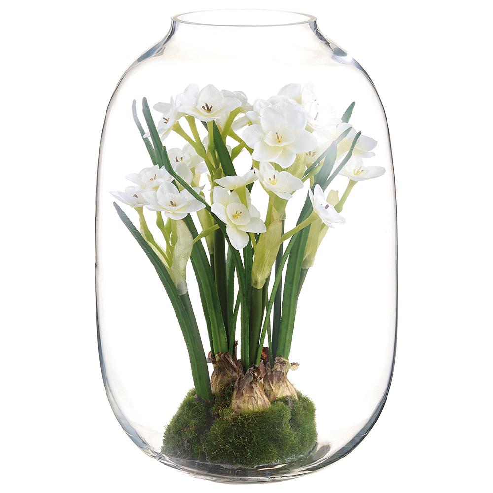 White glass vase holding a single artificial daffodil with green stem.