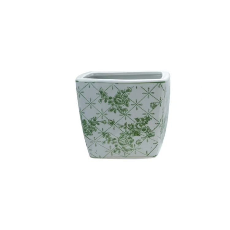 Square white stoneware planter with a green floral and lattice pattern.