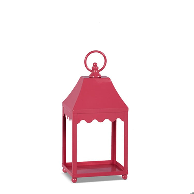 Pink iron lantern with a geometric cutout pattern