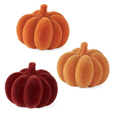 Three assorted 2.75 inch flocked resin pumpkins in orange, light orange, and deep red.