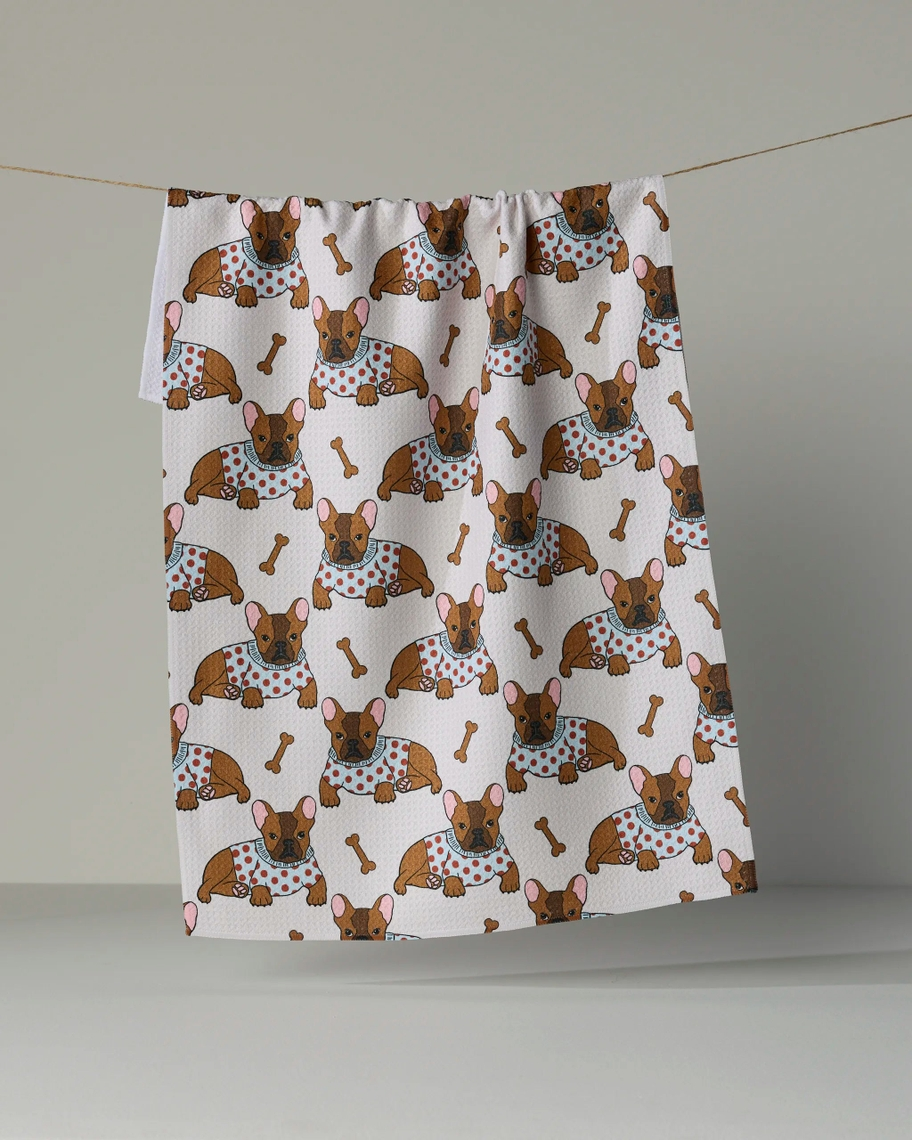 Everyday tea towel featuring a pattern of French bulldogs in polka dot sweaters and dog bones.