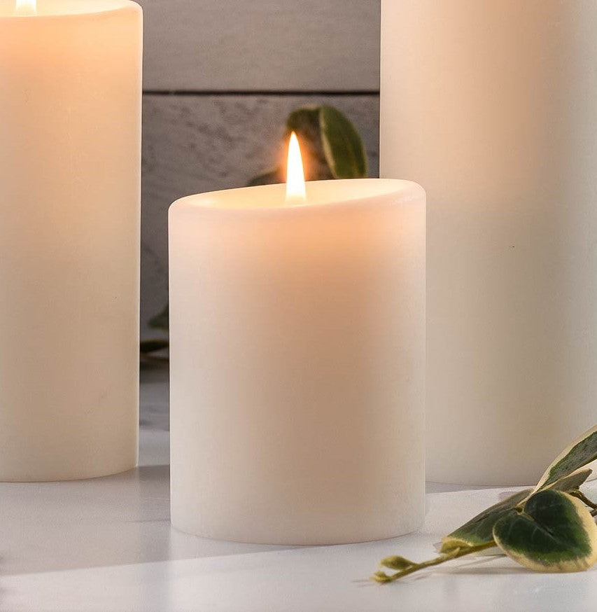 Natural white pillar candle with a smooth cylindrical shape.
