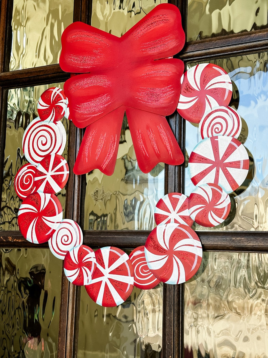 Holiday candy wreath with red and white striped candies arranged in a circular silhouette.