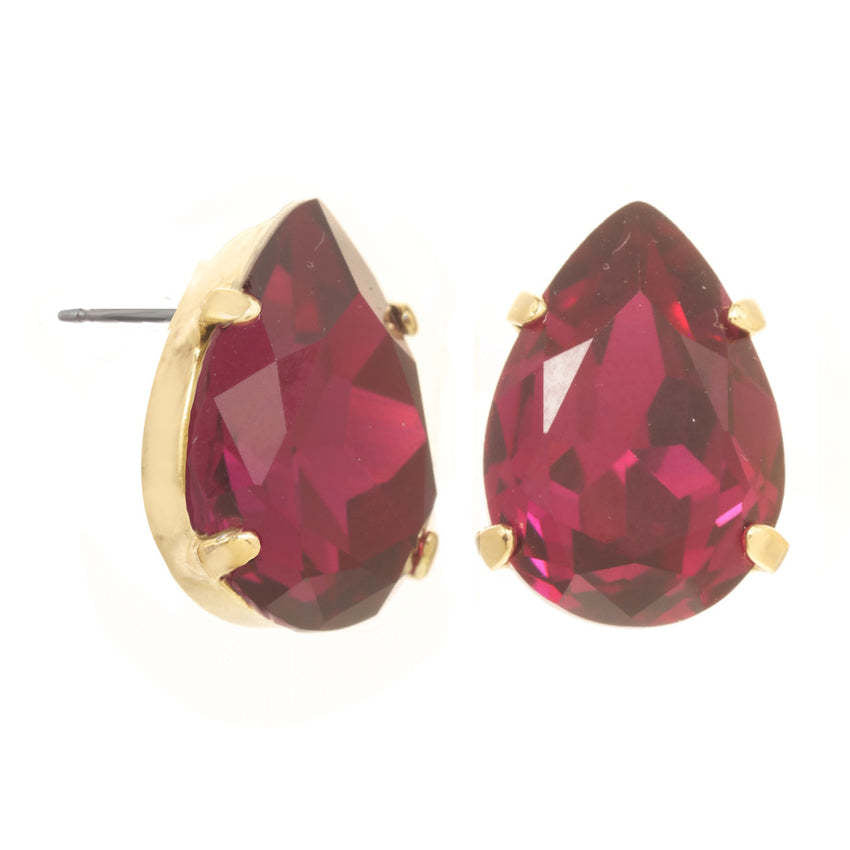 Lumi Studs Earrings featuring teardrop-shaped magenta crystals in gold-tone prong settings.