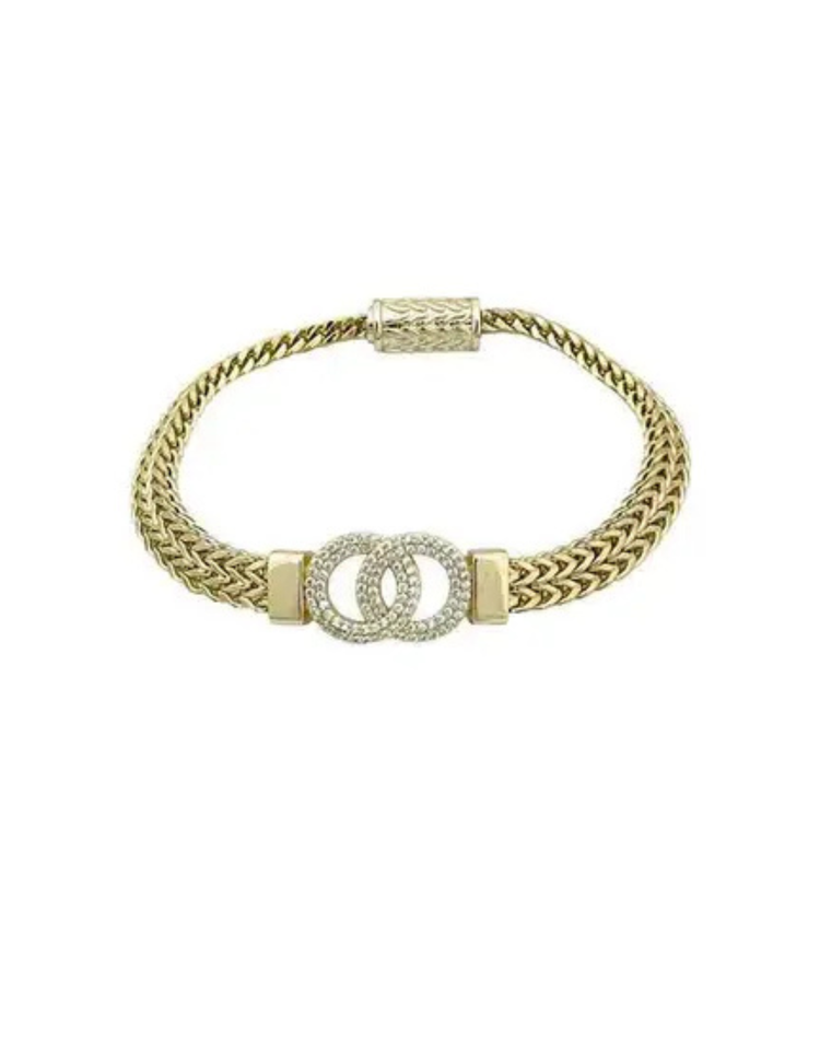 Two-tone interlocking mesh bracelet with a gold-tone chain and crystal-encrusted circular links.