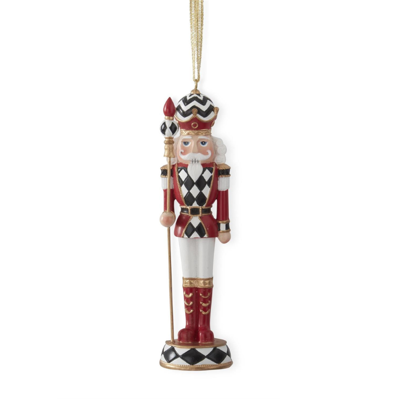 6.25 inch nutcracker ornament with red and black harlequin check patterns and gold trim.