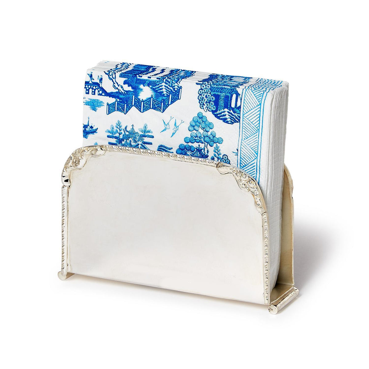 Silver-plated brass napkin holder with a stack of blue and white patterned paper napkins.