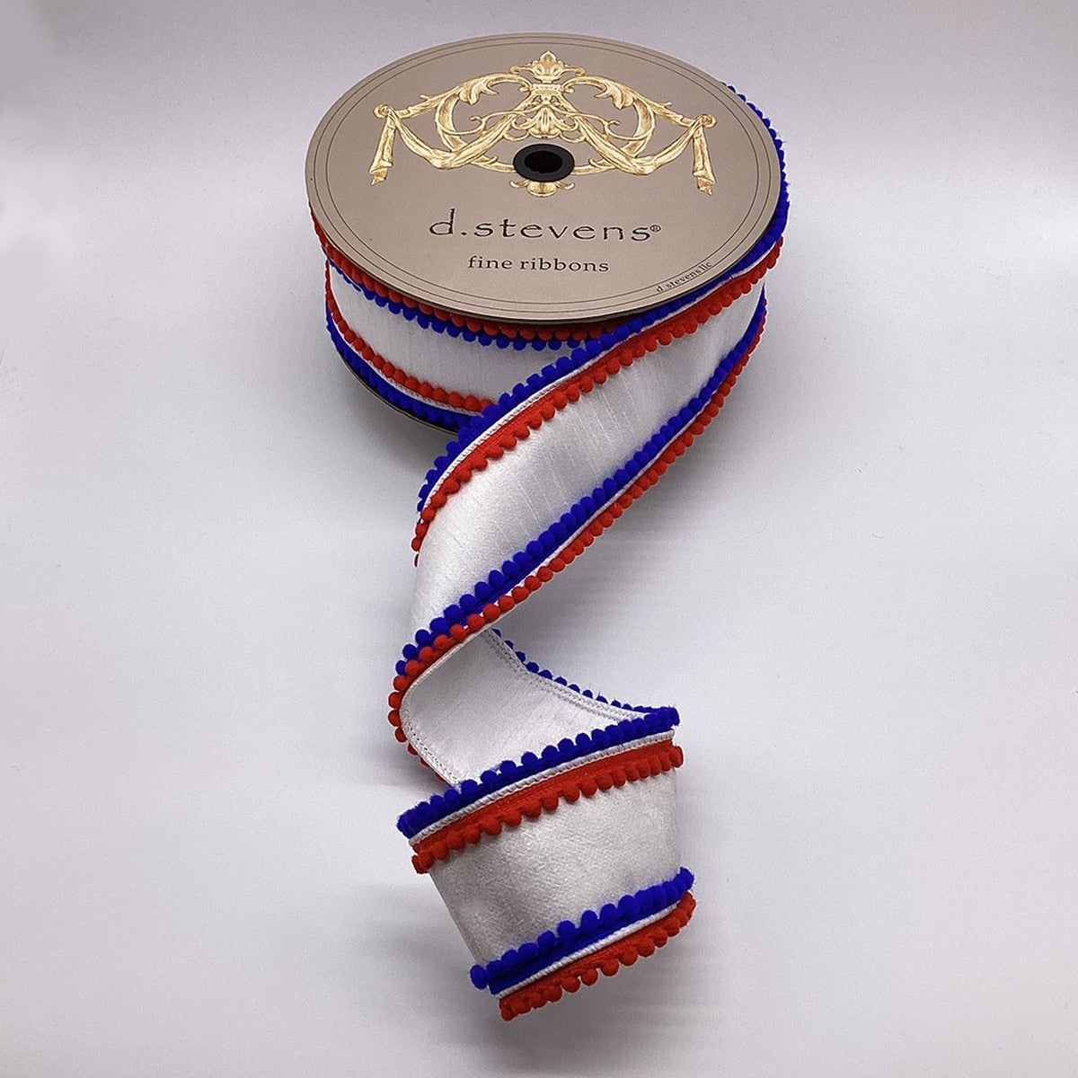 Red dupion fabric trim with royal blue pom poms and white ribbon