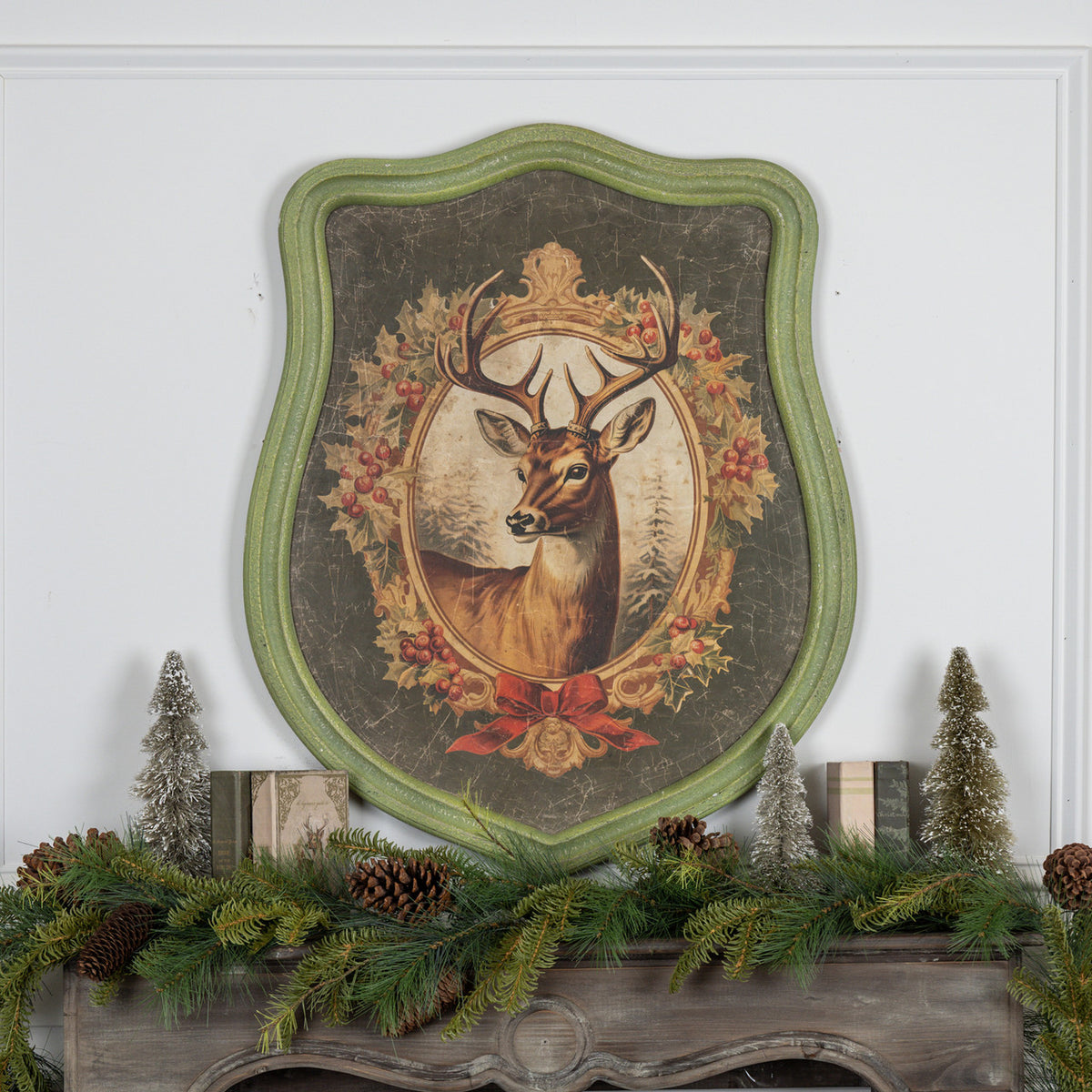 Framed holiday stag print on glass with wood frame showing a dark silhouette against a festive background.