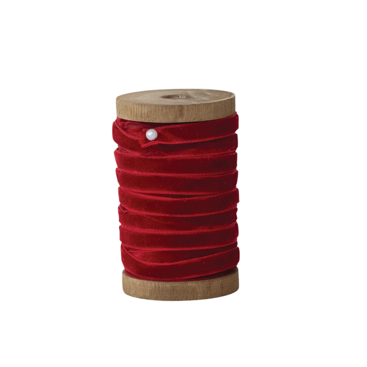 10 yards of 1/4 inch wide red velvet ribbon wrapped around a vintage-style wooden spool.