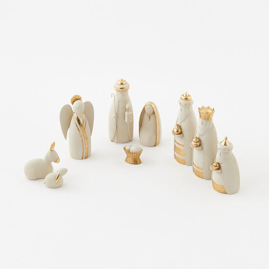 Nine-piece white and gold ceramic nativity set featuring minimalist figurines on a white background.