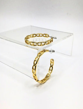 Gold polished large hoop earrings featuring an open chain link design on a clear display stand.