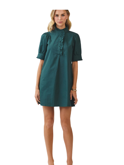 A woman wearing the Adda dark green short-sleeved dress with a ruffled high neck and button placket.