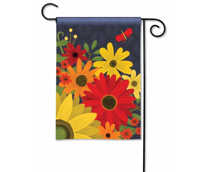 Green garden flag with white floral vine pattern on a pole.