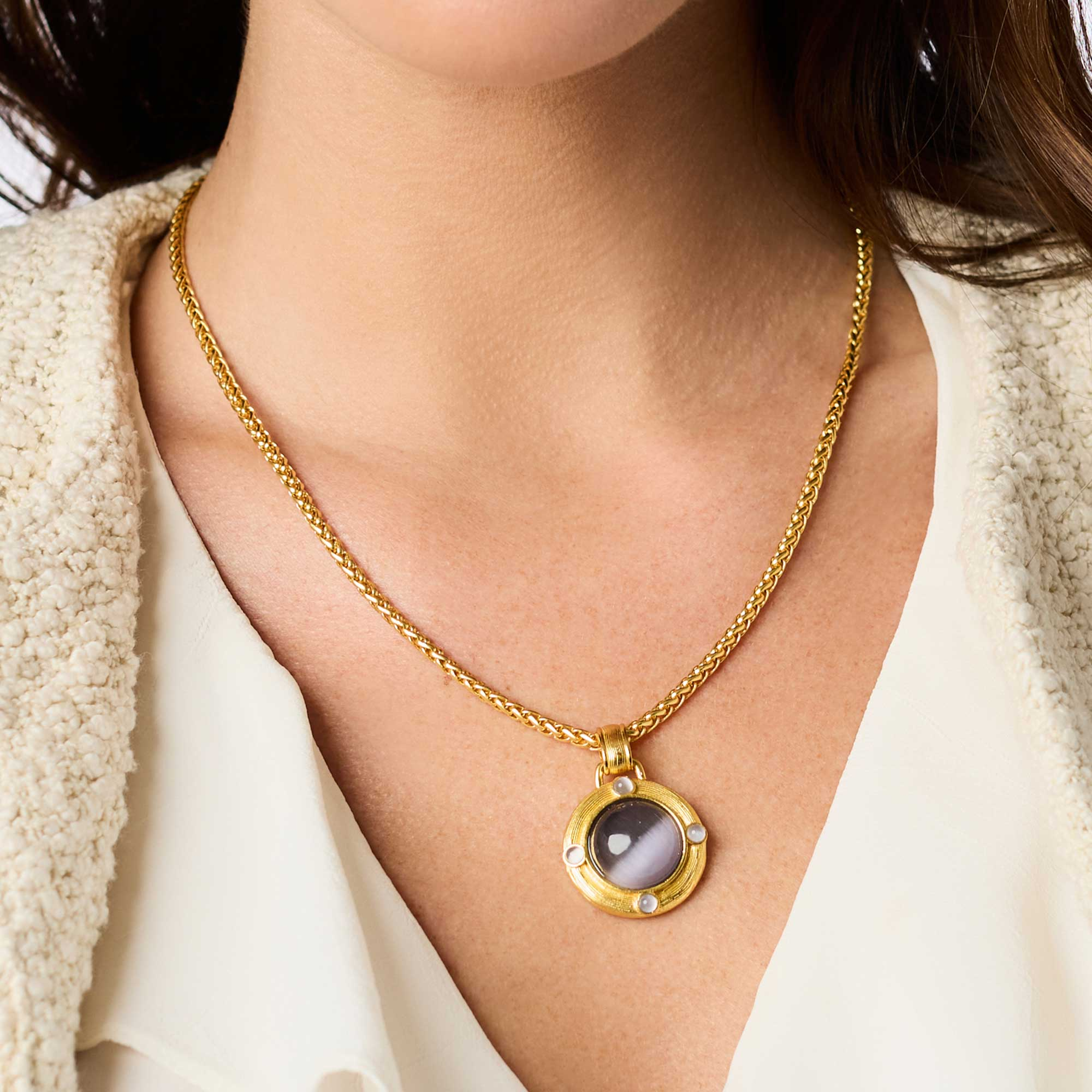 Woman wearing the Cobblestone Demi Necklace, a 24K gold plate chain with a round glass pendant.