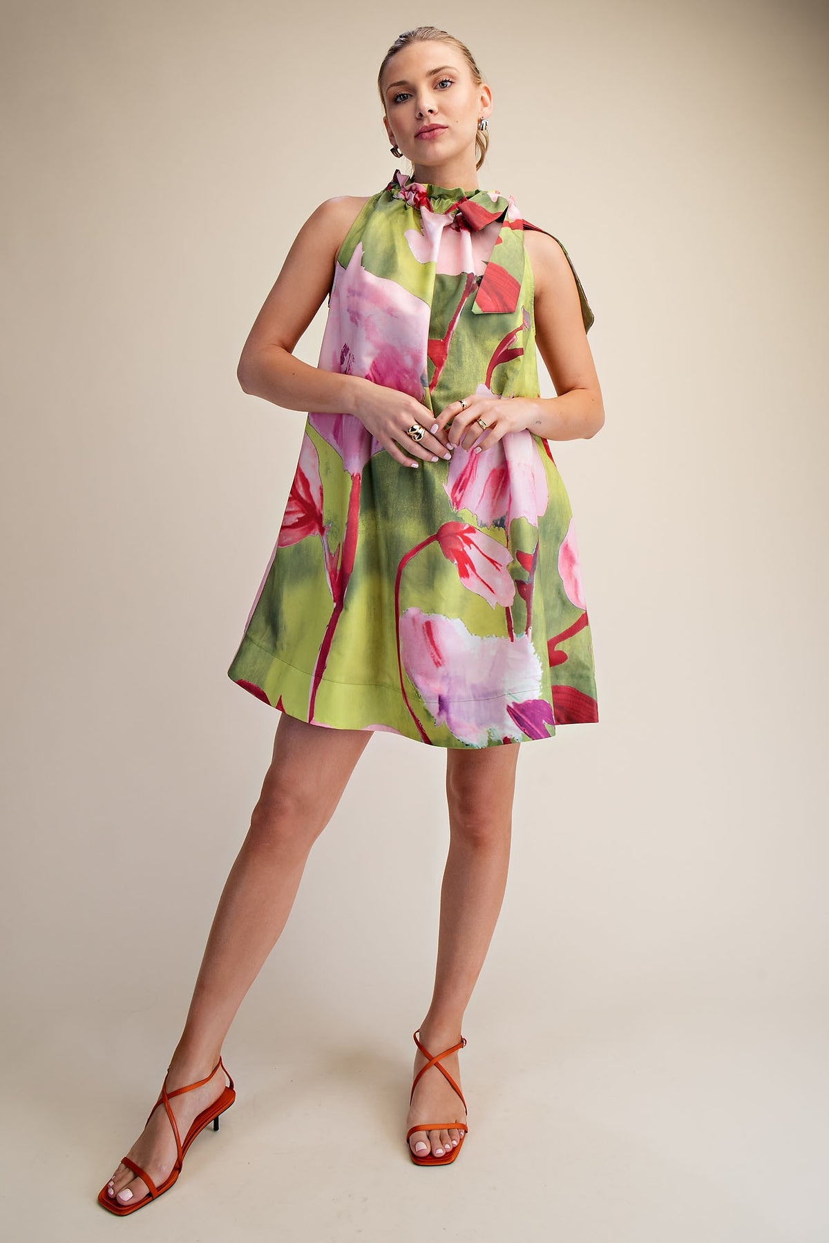 Sleeveless floral print mini dress with ruffle neckline in polyester fabric