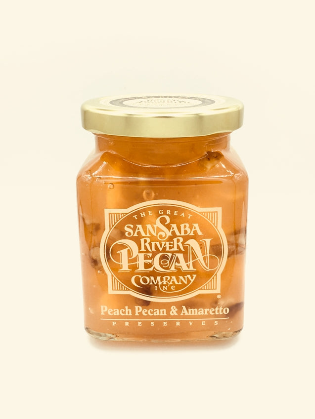 Glass jar containing Texas cranberry preserves with pecans