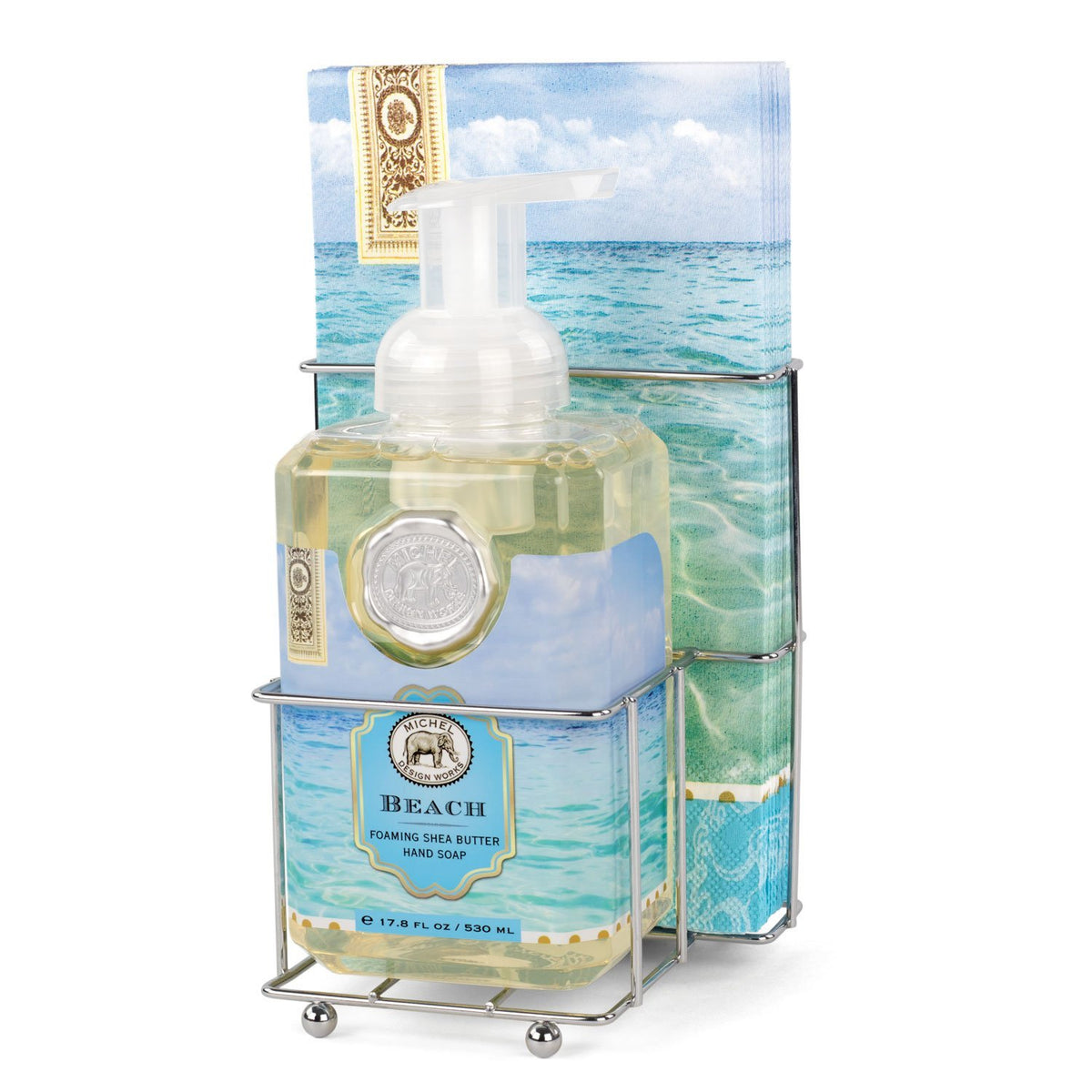 Compact foaming hand soap dispenser with matching napkin holder in neutral tones.