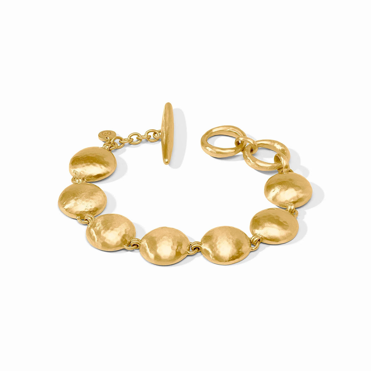 Solara gold-plated bracelet featuring hammered circular discs and a toggle closure.