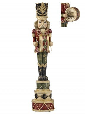18-inch resin nutcracker figurine playing a drum and standing on a stack of three decorative drums.