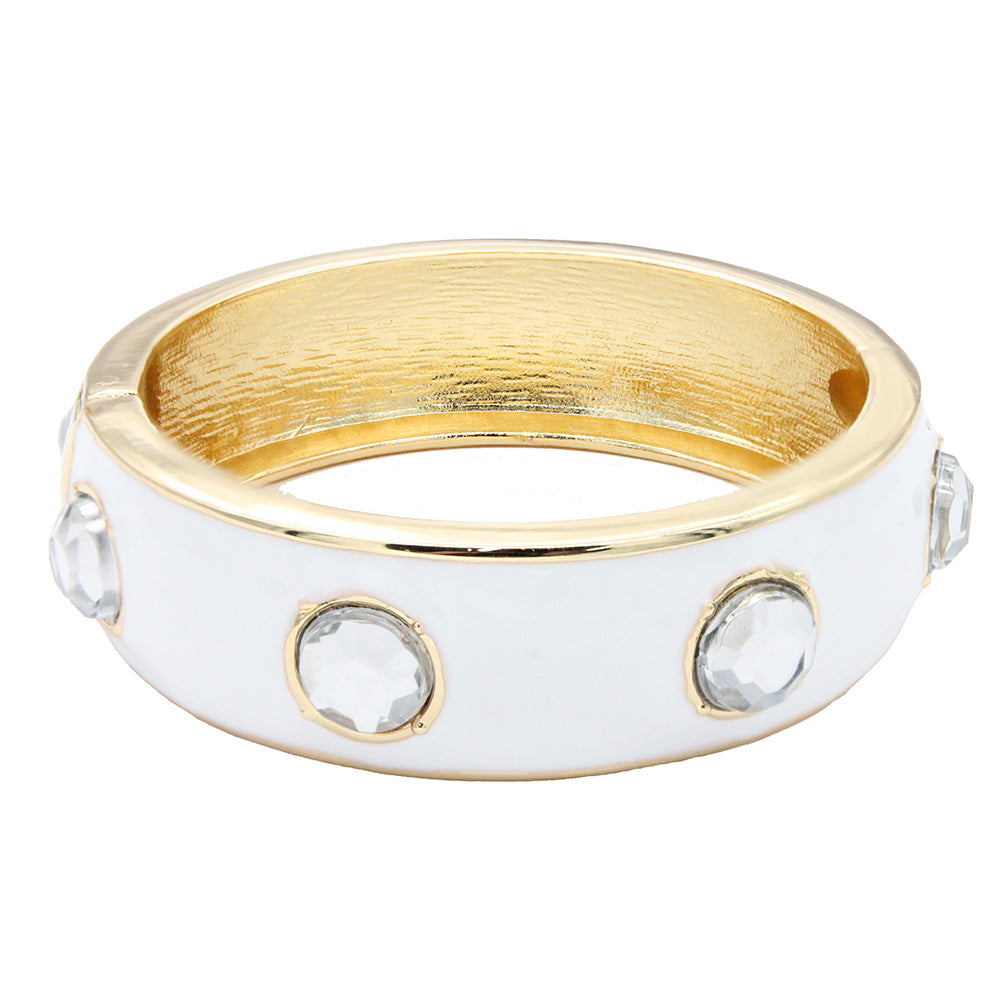 Gold plated hinged bangle bracelet with white enamel and round clear crystal accents.