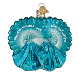 Sisters Sisters Ornament featuring two silhouettes in a warm tone with decorative patterns on a festive background.