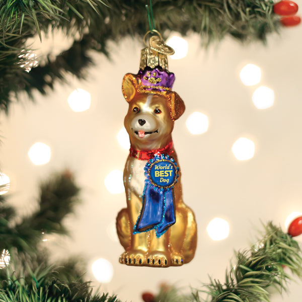 Red ceramic dog ornament with gold collar hanging from a green Christmas tree branch.