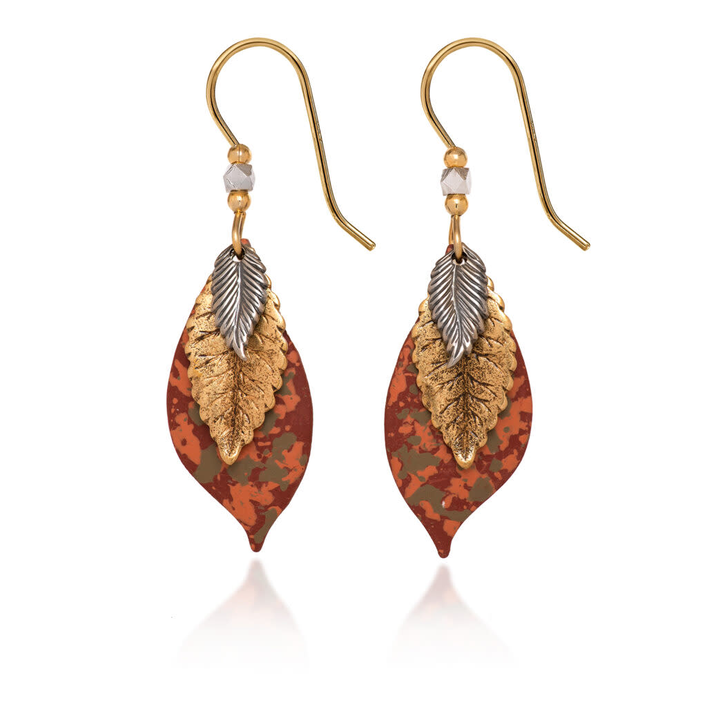 Mixed metal layered leaf earrings with gold, silver, and patterned copper tones on gold ear wires.