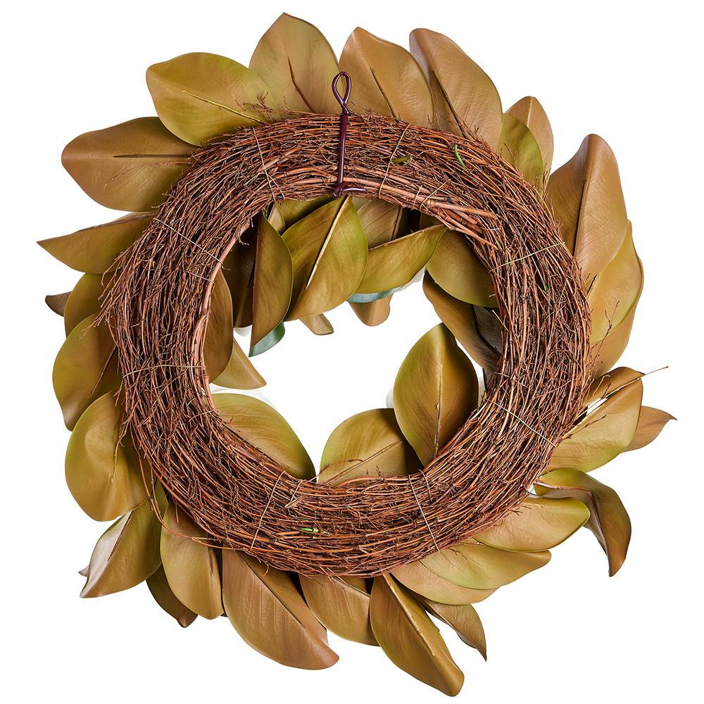 White plastic magnolia wreath with green accents in a circular shape