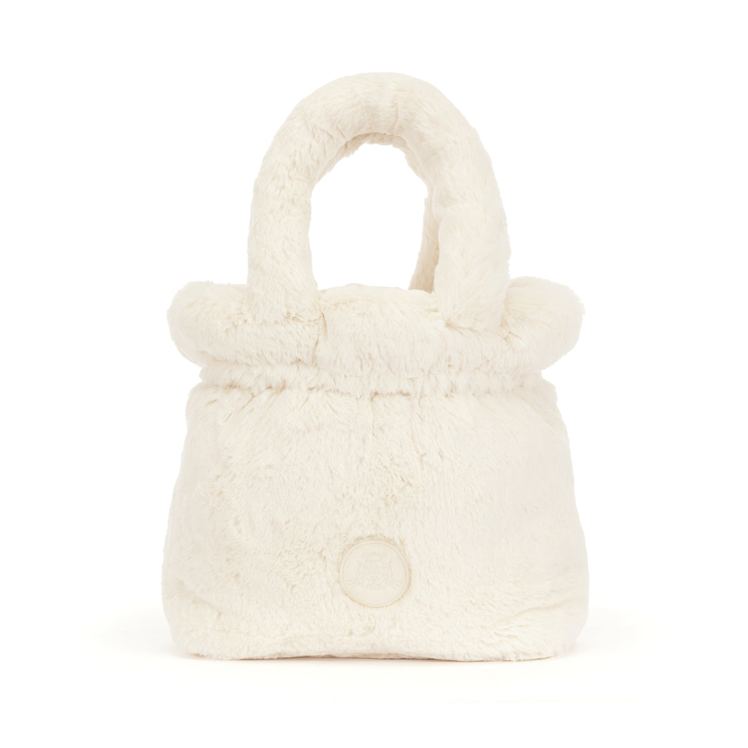Rufferty Puppy Handbag made of soft, cream-colored faux fur with a matching top handle.