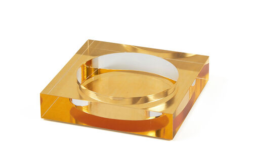 Square gold Lucite wine bottle coaster with a sleek modern silhouette.