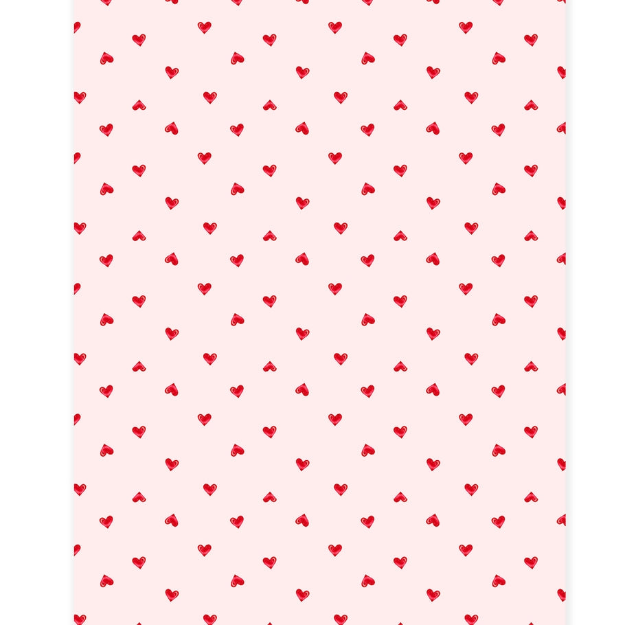 White paper table runner with a subtle sheen featuring a ditsy pattern of small hearts.