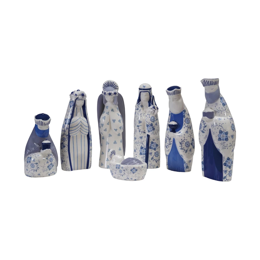Seven-piece blue and white ceramic nativity set with floral patterns and solid blue accents.