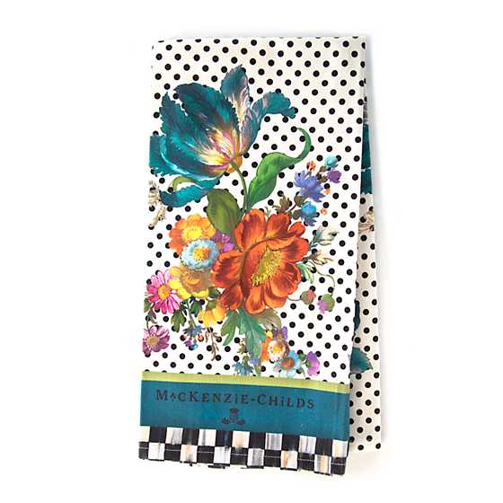 White cotton dish towel with a floral market print featuring green leaves and colorful flowers.
