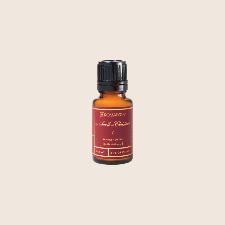 Aromatique The Smell of Christmas Refresher Oil in a 0.5 fl oz amber glass bottle with a black cap.