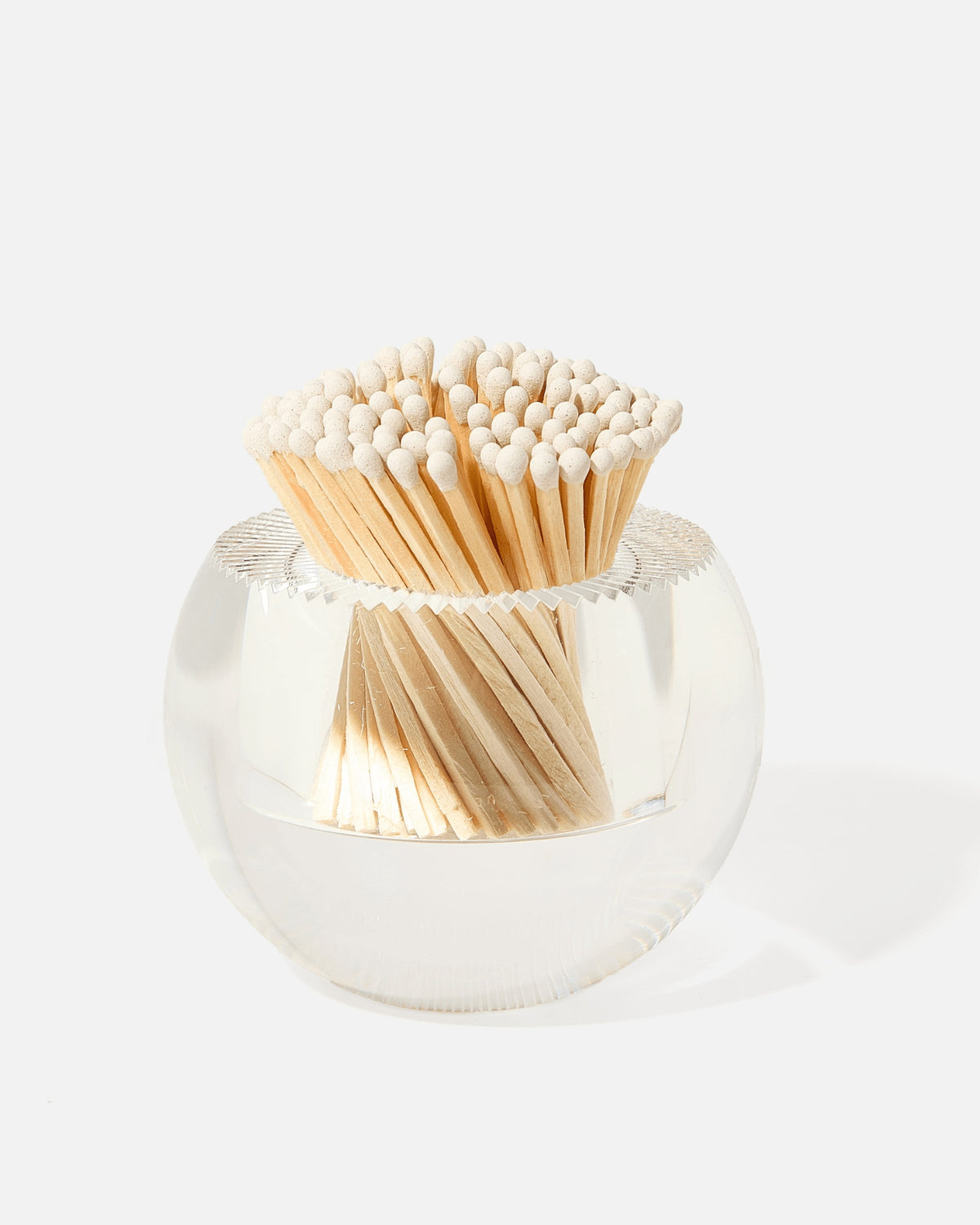 Round clear glass match striker filled with white-tipped wooden matches.