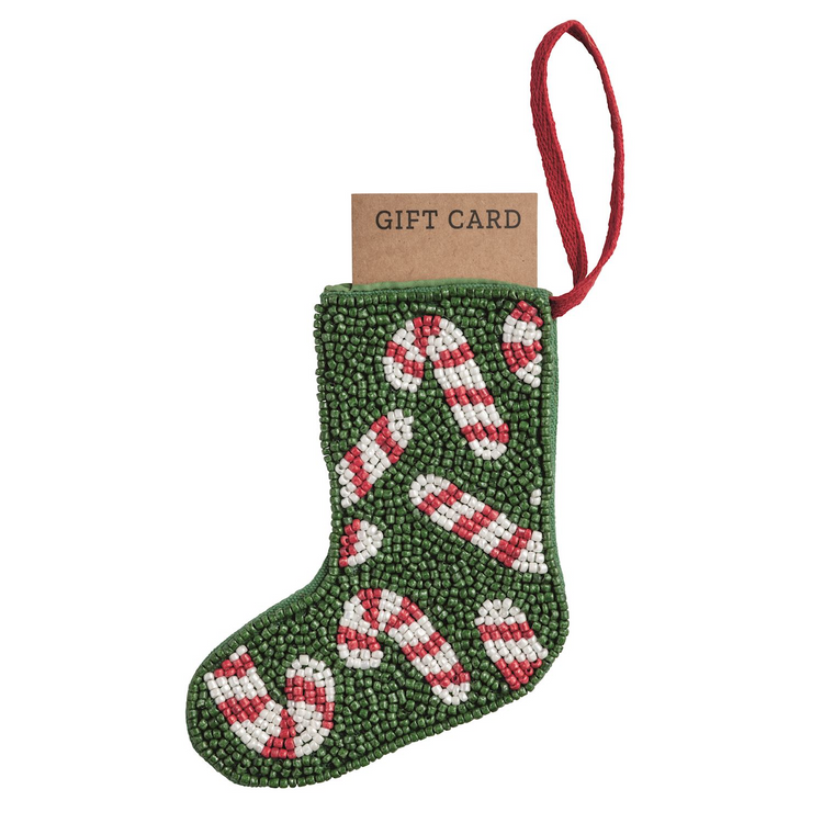 Green beaded stocking ornament with candy cane designs and a red loop hanger holding a gift card.