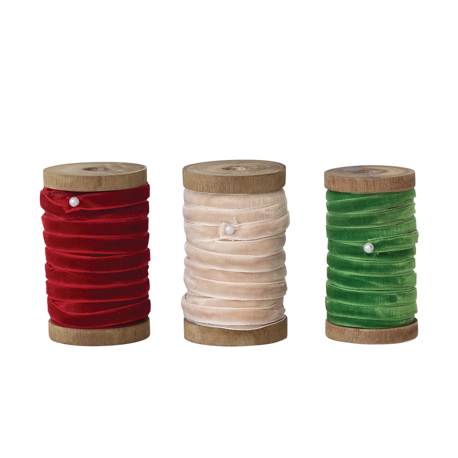 Three wooden spools of 1/4 inch velvet ribbon in red, cream, and green, secured with pearl pins.
