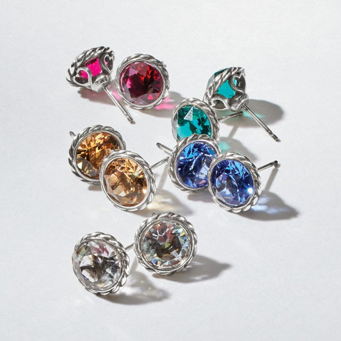Five pairs of Iris Stud Earrings in pink, teal, amber, blue, and clear crystals with silver plating.