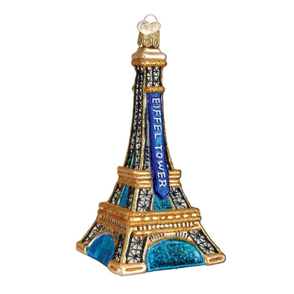 White Eiffel Tower ornament with gold accents on a clear stand