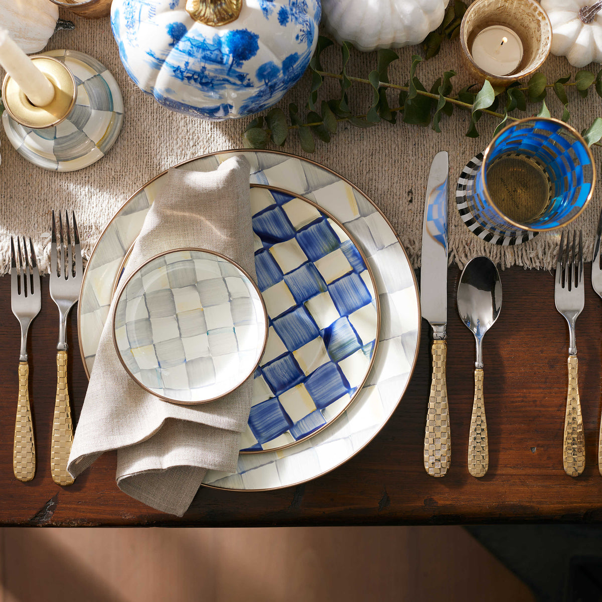 Sterling Check Dipping Bowl on a grey napkin atop a layered place setting with blue and white decor.