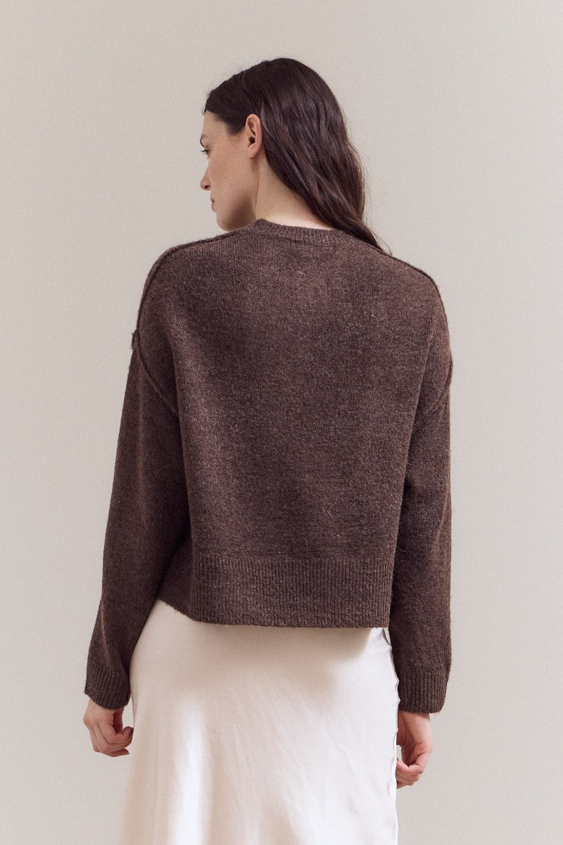 Natasha half button down sweater in a soft neutral tone with long sleeves and a relaxed silhouette.